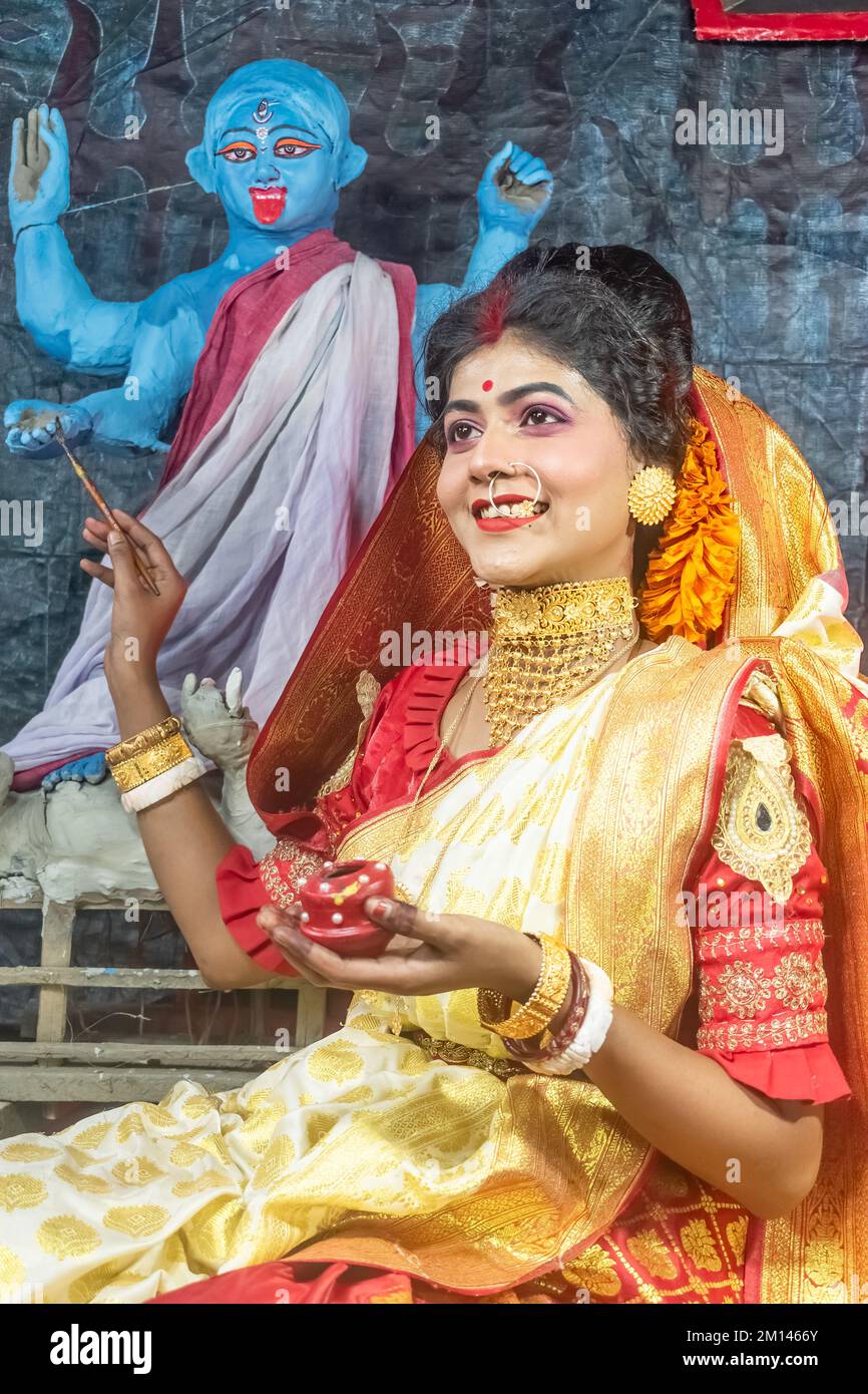 kali Puja Look Photo-shoot based on Festival with ethnic look.like A face  of Hindu married woman.front of an idol ,Happy Navratri Stock Photo - Alamy