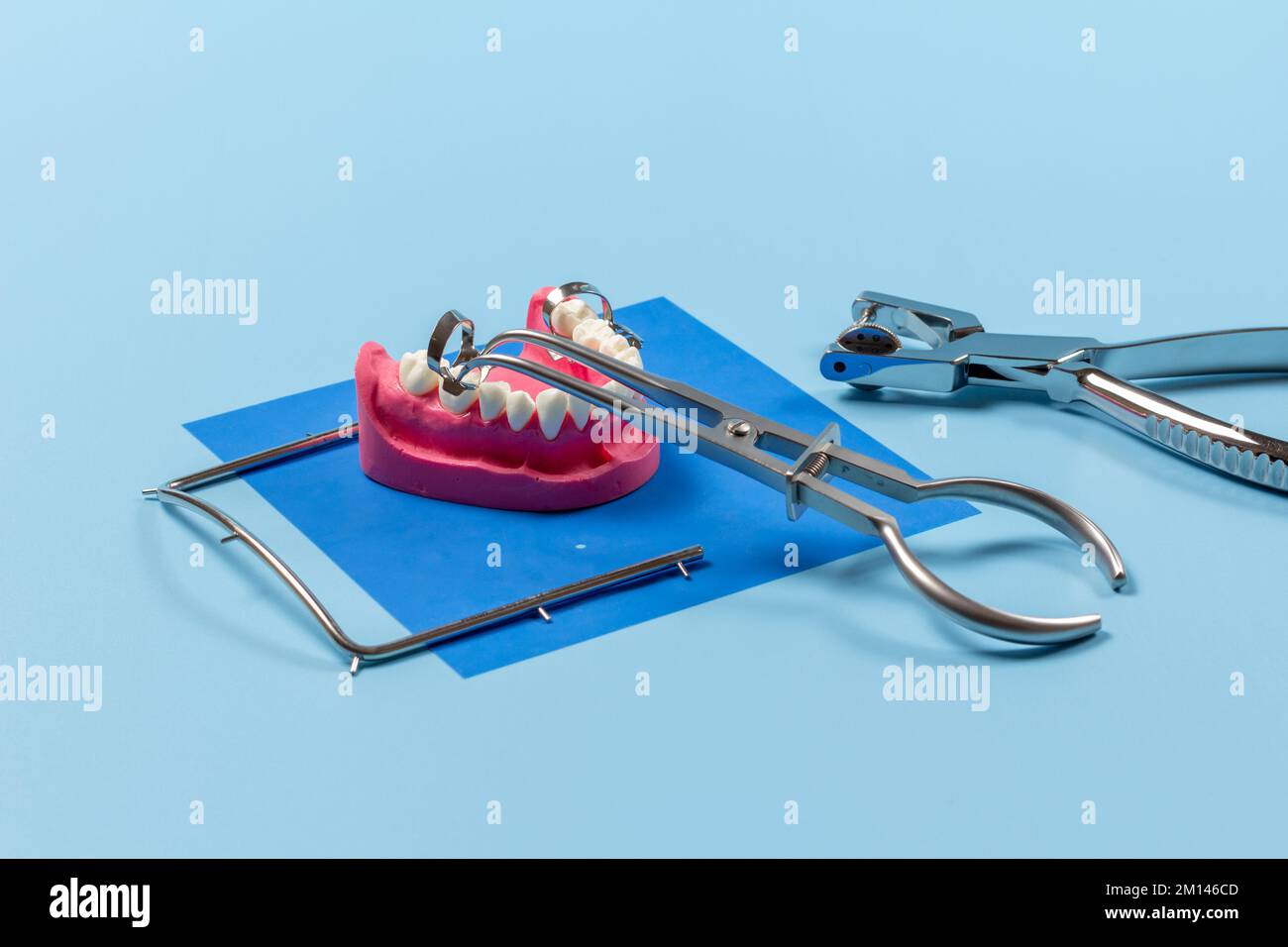 Dental hole punch, the metal frame and the rubber dam forceps with