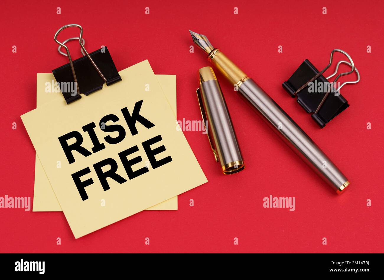 Business concept. On a red background, a pen and stickers with the ...