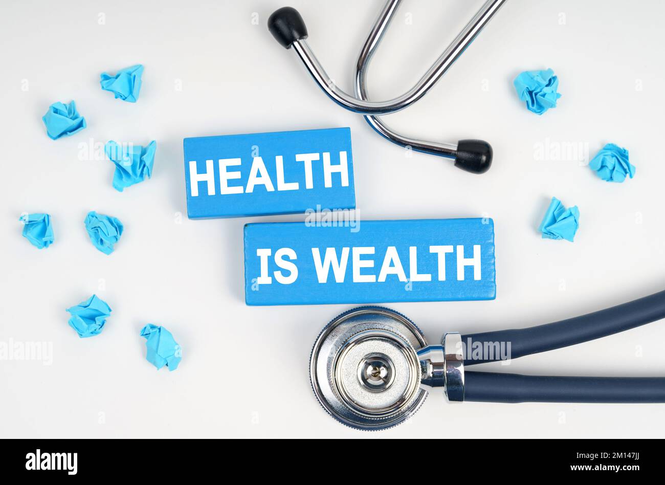 Medicine and health concept. On the table is a stethoscope and blue Jenga with the inscription - Health Is Wealth Stock Photo