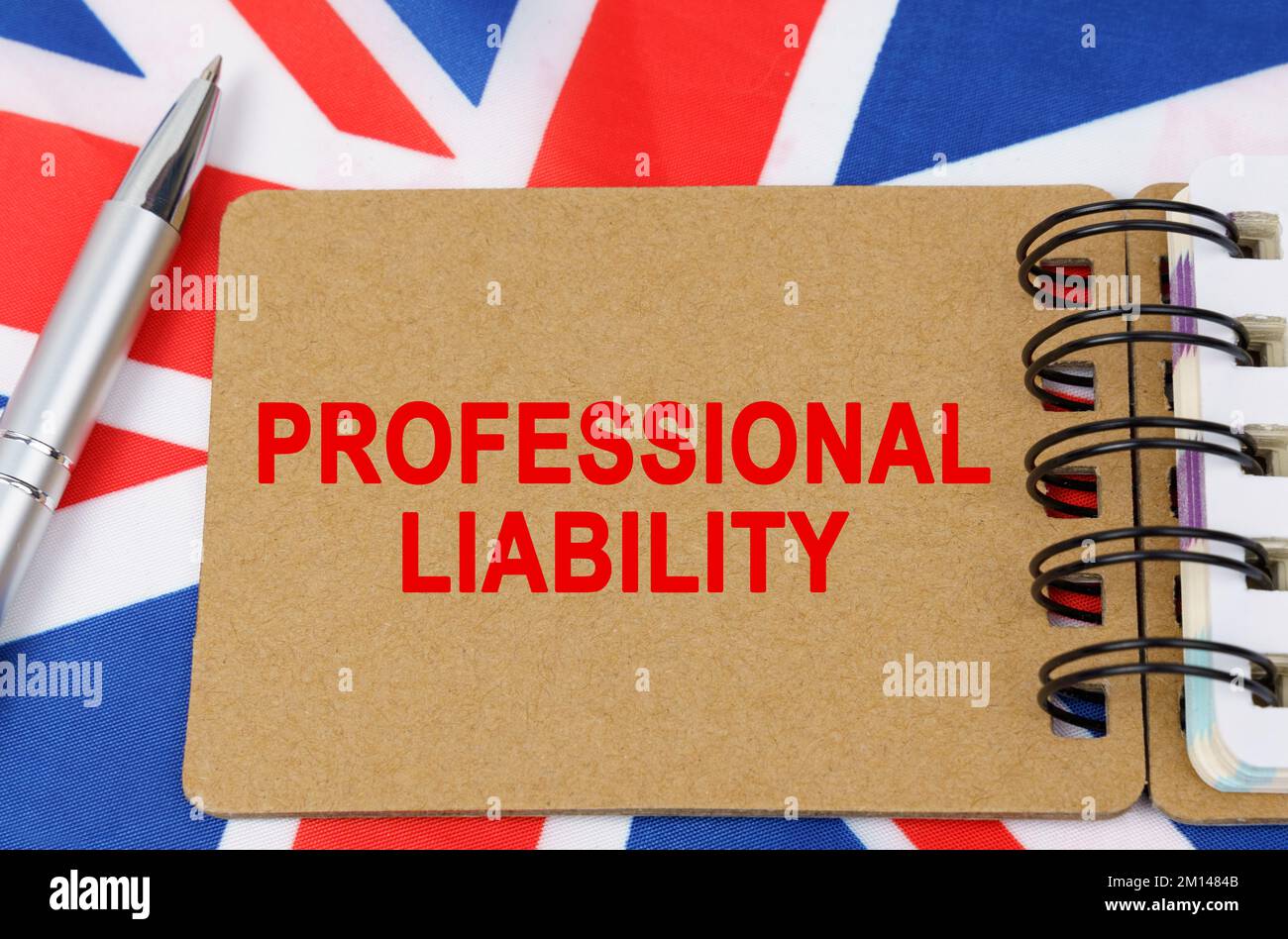 Law and justice concept. Against the background of the flag of Great Britain lies a notebook with the inscription - PROFESSIONAL LIABILITY Stock Photo