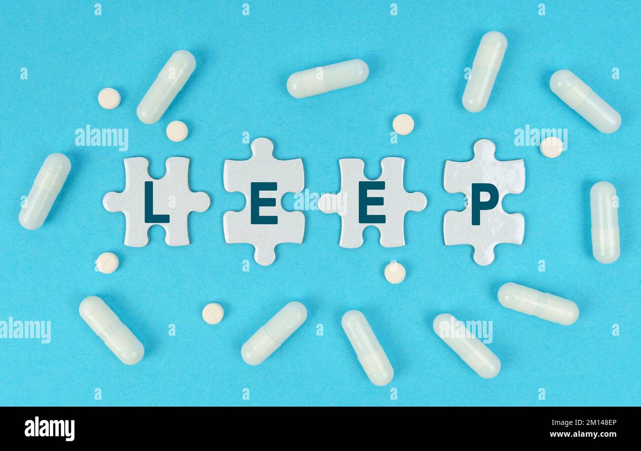 Medicine and health. On a blue background, there are pills and puzzles with the inscription - LEEP Stock Photo