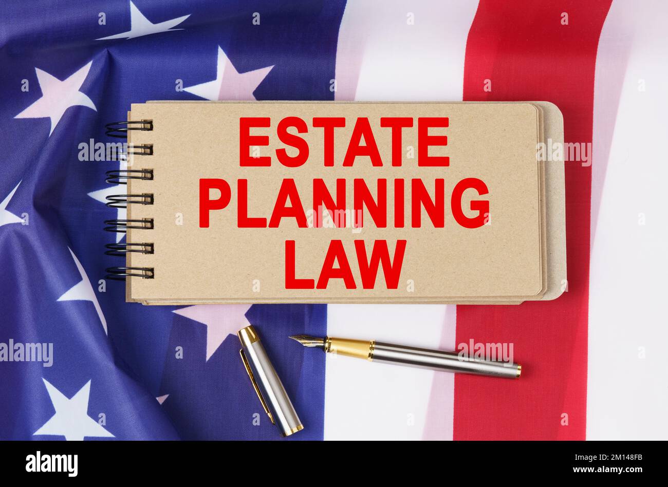 Law and order concept. Against the background of the flag of the United States of America lies a notebook with the inscription - ESTATE PLANNING LAW Stock Photo