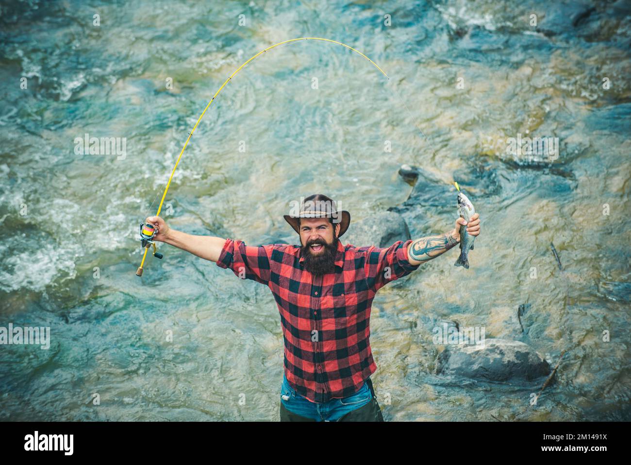 Fisherman fishing on a rever. Excited amazed fisher man in water ...