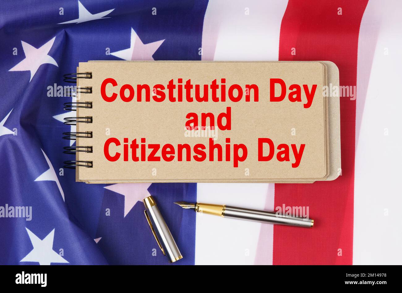 USA Holidays. Against the background of the US flag lies cardboard with the inscription - Constitution Day and Citizenship Day Stock Photo