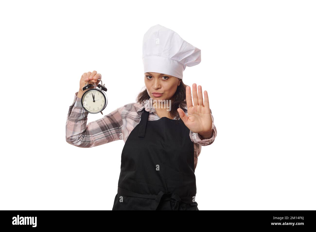 Female waitress, cafe worker in black apron holding alarm clock