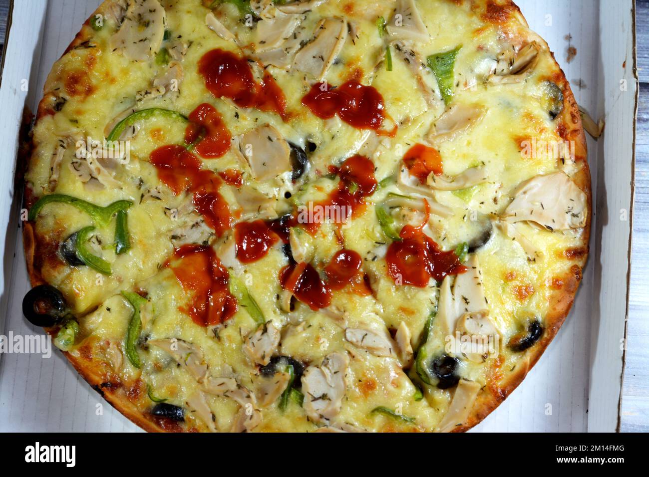 Mushroom pizza with slices of olive, pepper, mozzarella, ketchup and