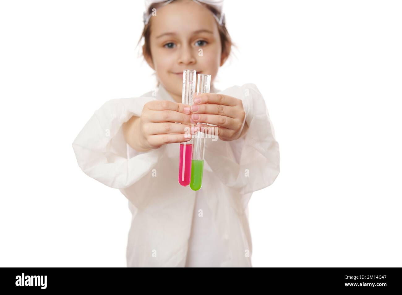 Little child's hands hold out test tubes and show the current chemical