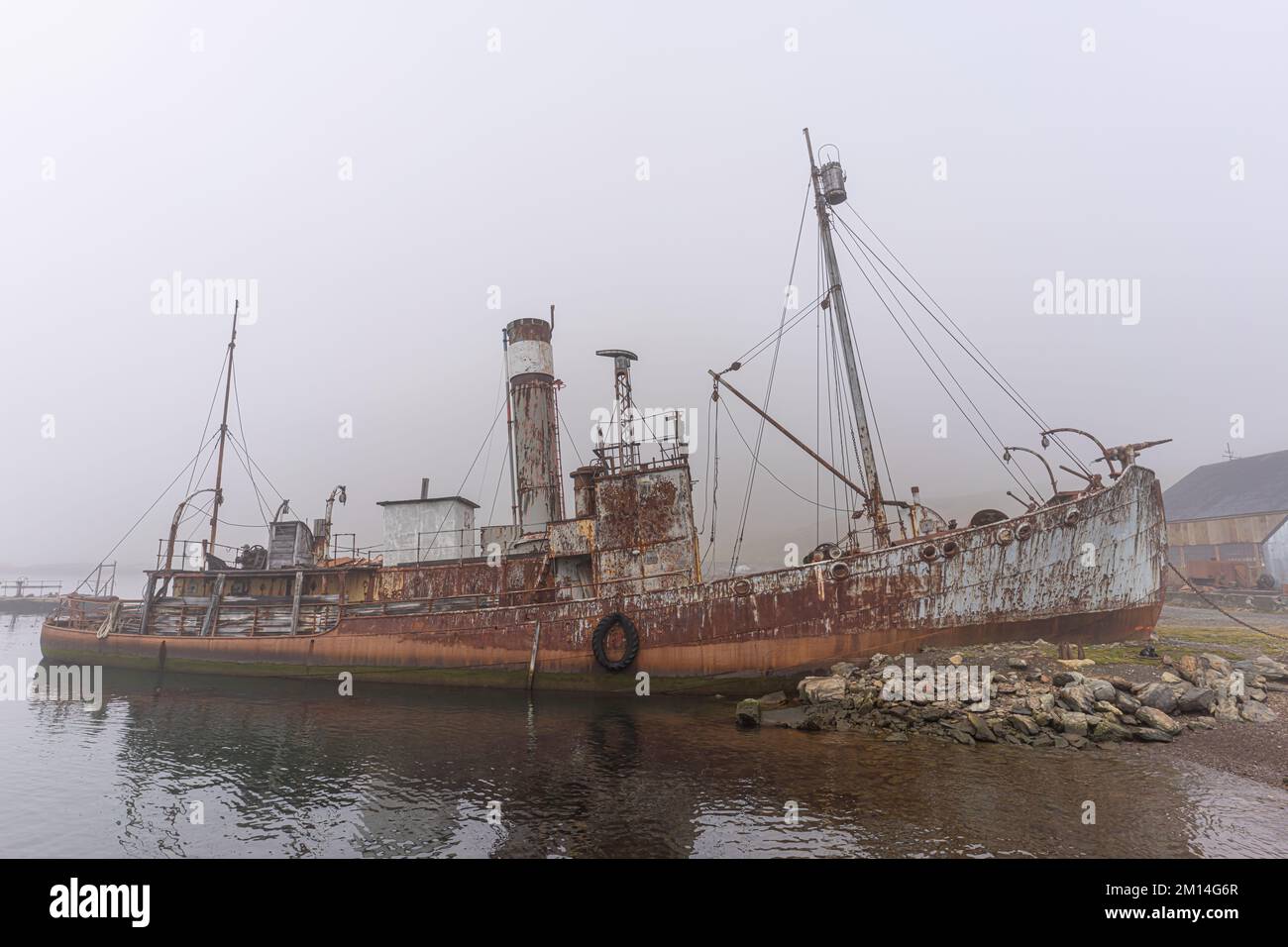 Old, rusty whaling ships and processing facilities at a now abandoned ...