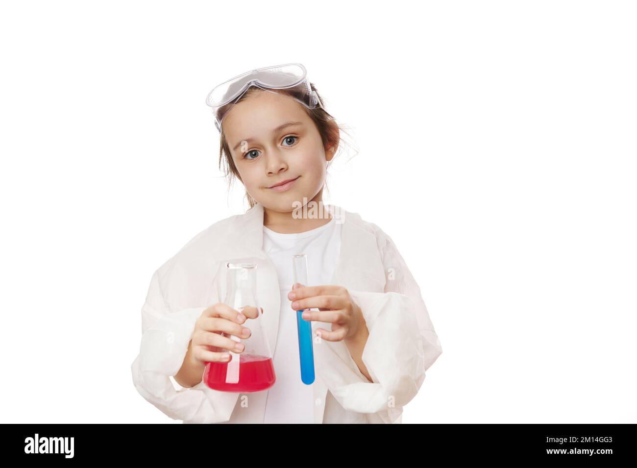 Happy smart little girl in lab coat, holding test tube and lab flask ...