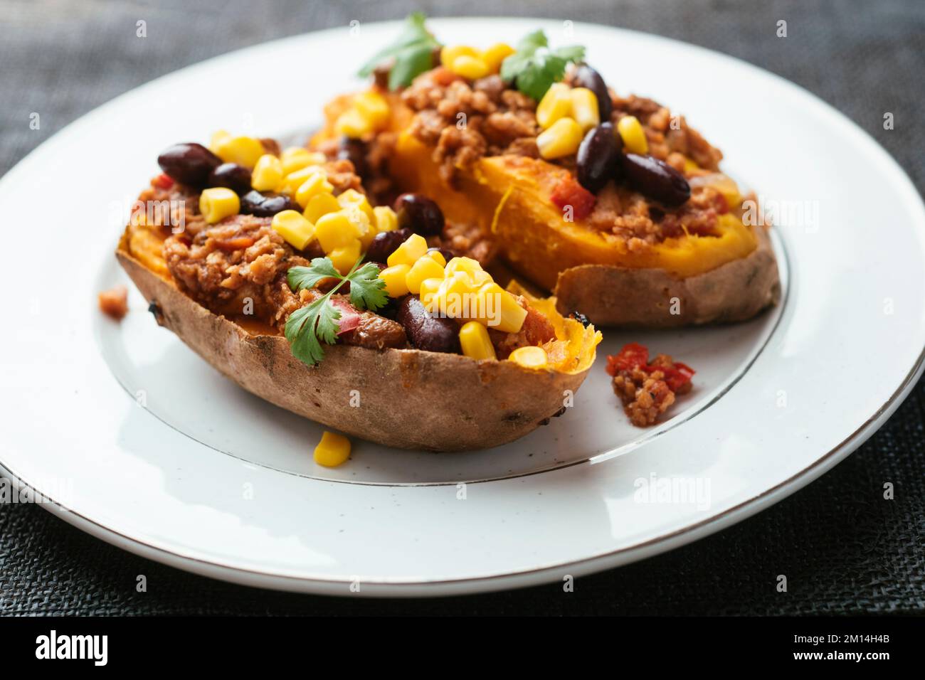 Loaded sweet potatoes with TVP granules, kidney beans and corn Stock Photo