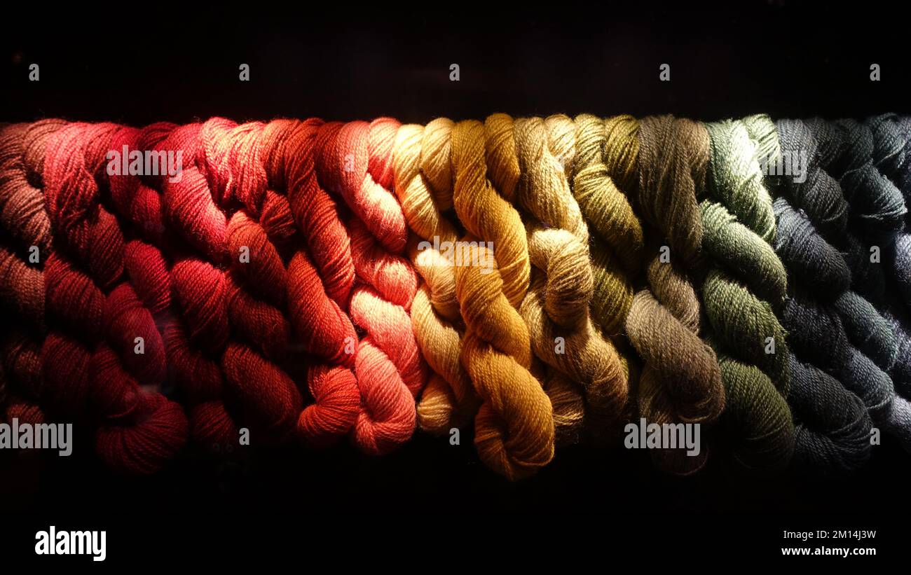 A band of colored and woven wool on a black background. Stock Photo
