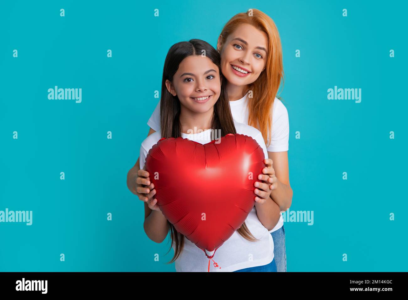 Mothers day. Smiling mother and daughter isolated on blue background