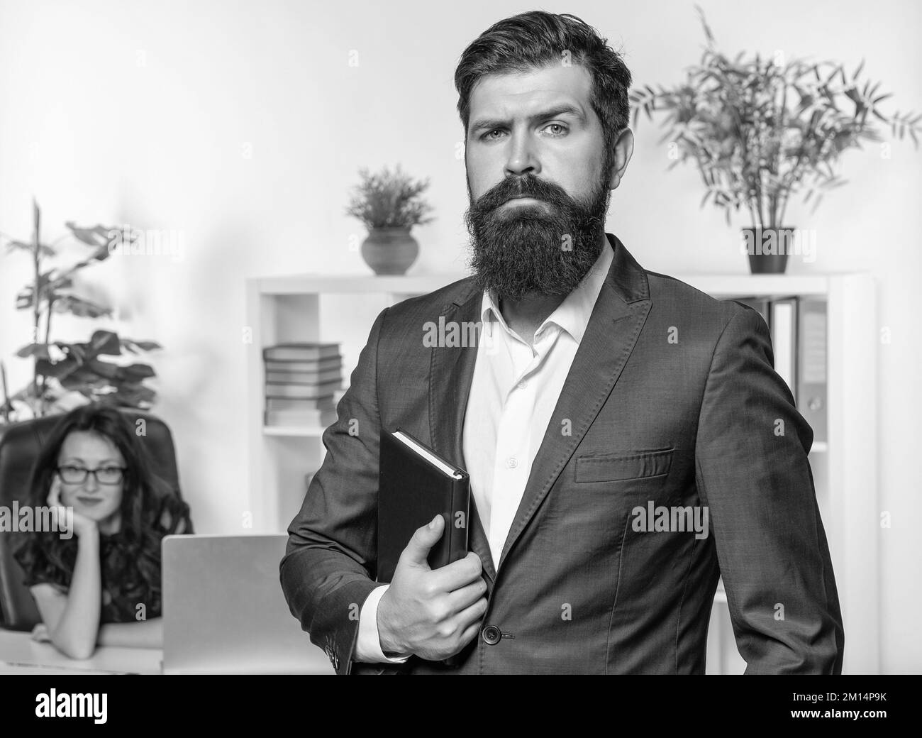 Serious man professional employer in suit stand in front woman employee