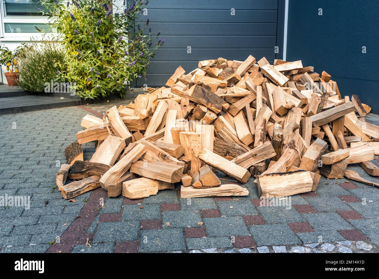 A pile of stacked firewood, prepared for heating the house.  Firewood harvested for heating in winter Stock Photo