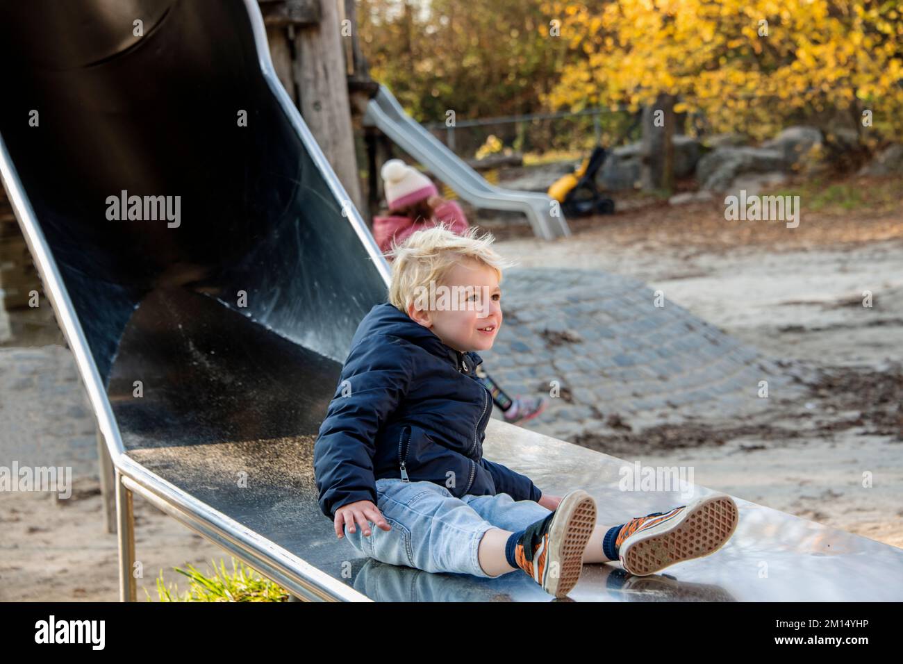 Near view of a young child at the playground on a sunny day Stock Photo