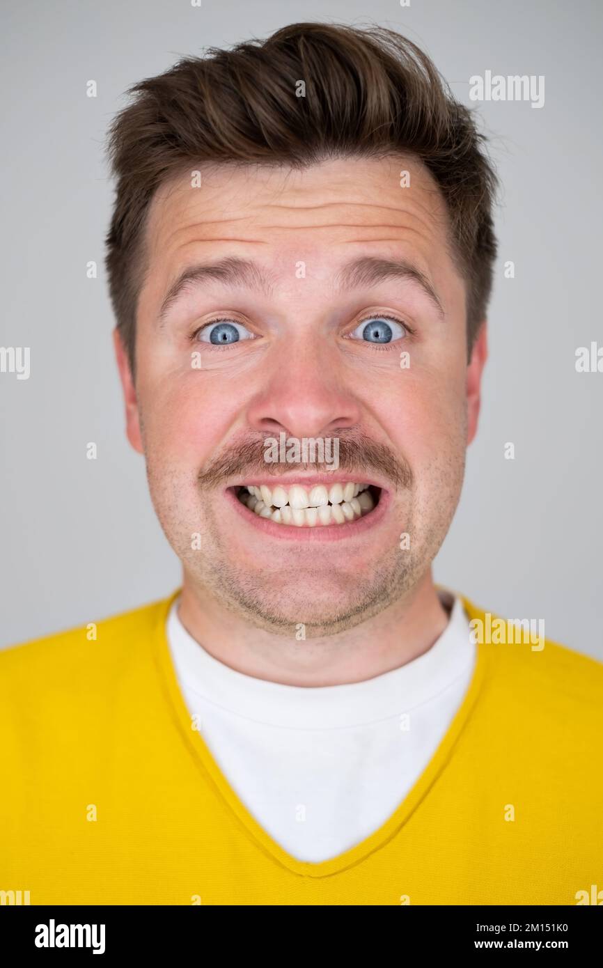 Caucasian crazy man with fake smile on face.  Stock Photo