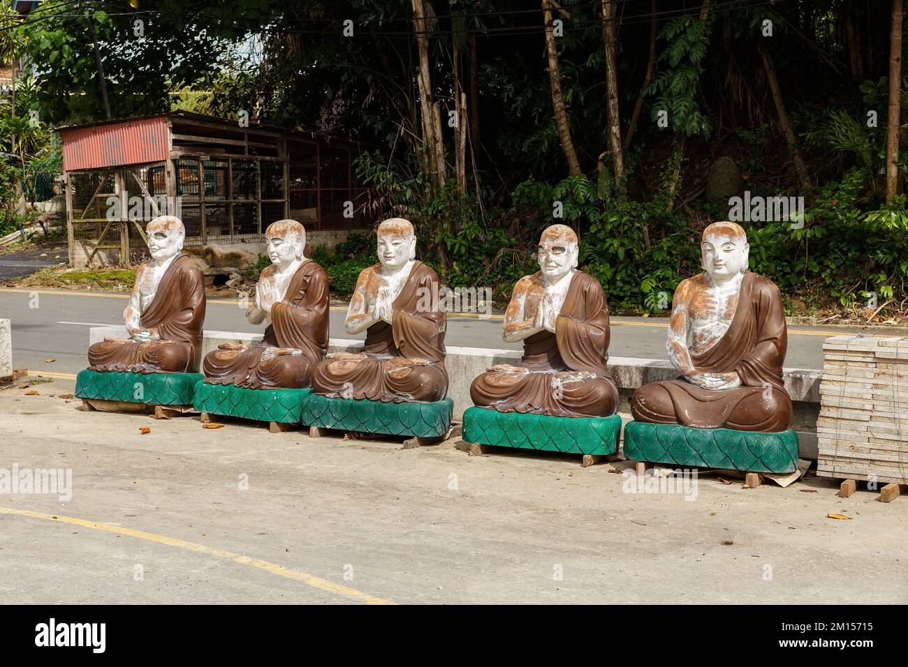 Air Itam, Penang, Malaysia - November 27, 2017: Kek Lok Si Temple. Stone Statues of monks near the road. Stock Photo