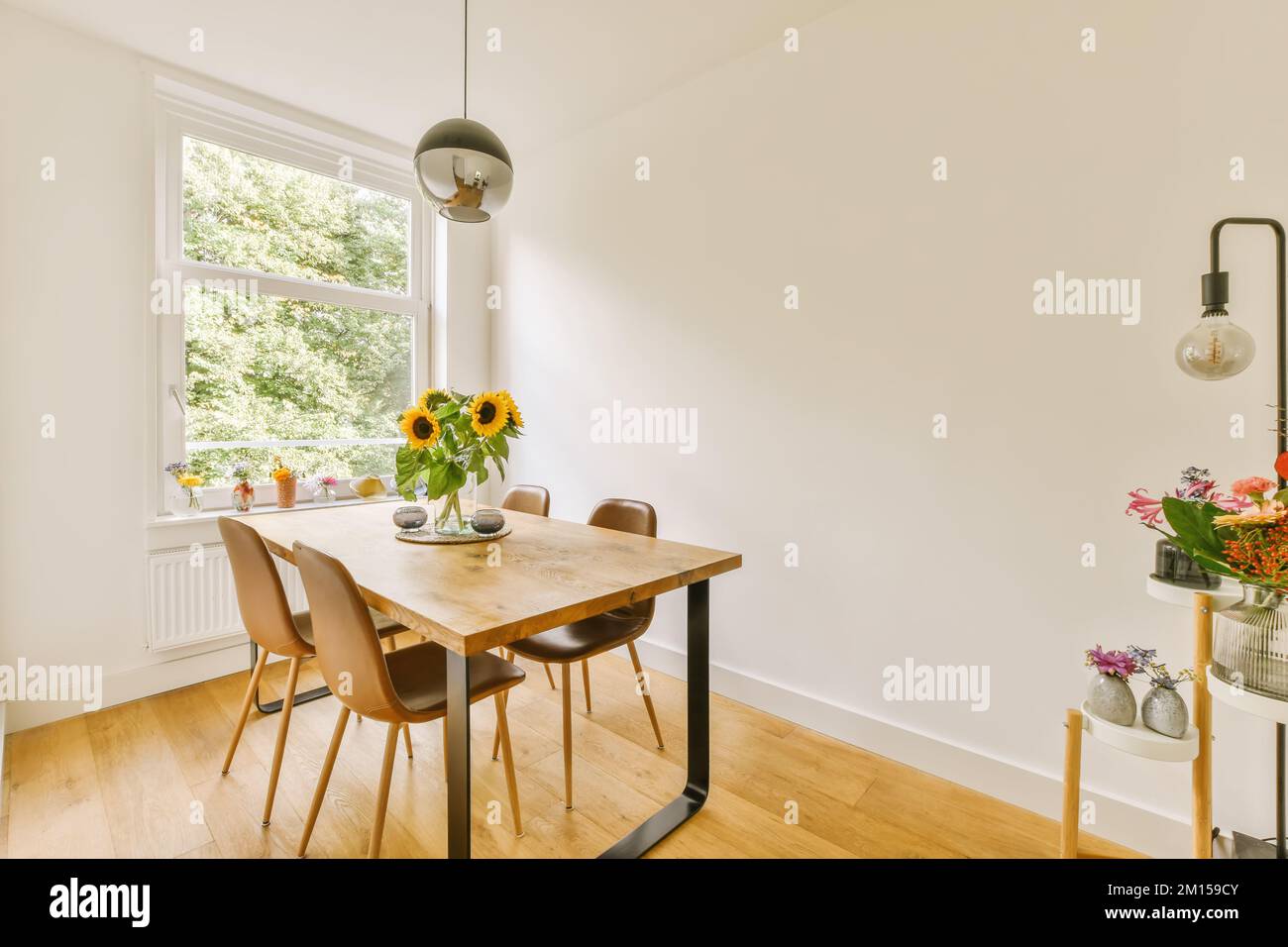 a dining table and chairs in a room with white walls, wood flooring and ...