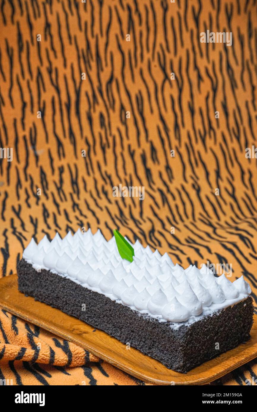 A closeup of Jane Parker Spanish bar cake on the brown striped