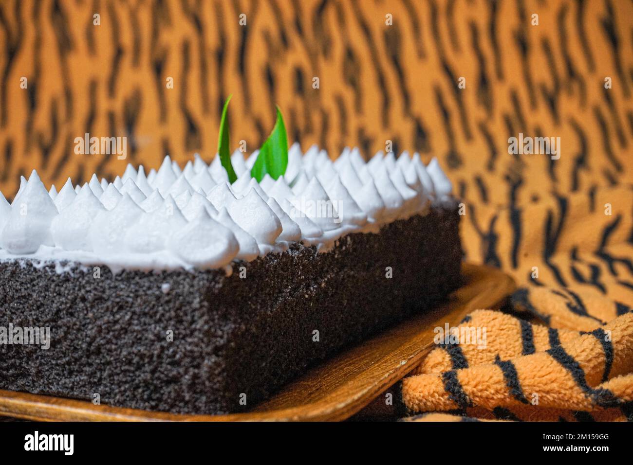 A closeup of Jane Parker Spanish bar cake on the brown striped background Stock Photo