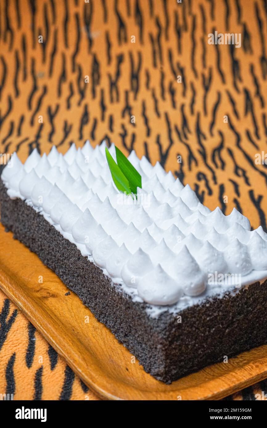 A closeup of Jane Parker Spanish bar cake on the brown striped background Stock Photo