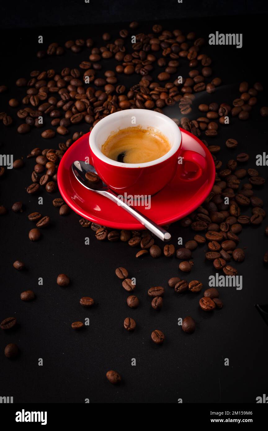 Espresso in red espresso cup with coffee beans Stock Photo Alamy