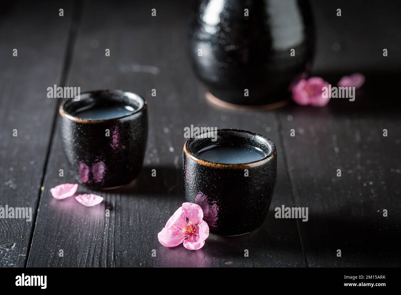 Strong Japanese sake with blooming pink flowers. Traditional highalcohol drink in Japan Stock