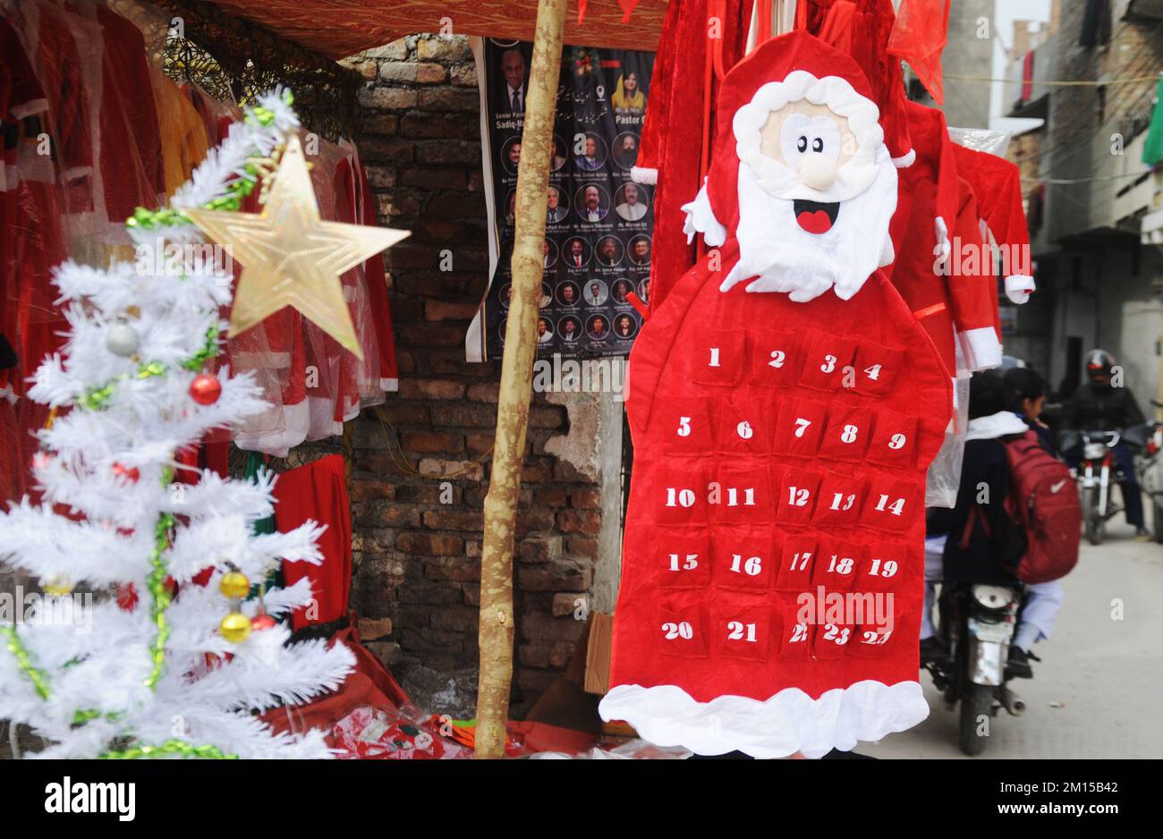 ISLAMABAD, PAKISTAN.A vendor is displaying and selling Santa Claus outfits for the Christmas festival at G-7/2.Photo by Raja Imran Bahadar Stock Photo