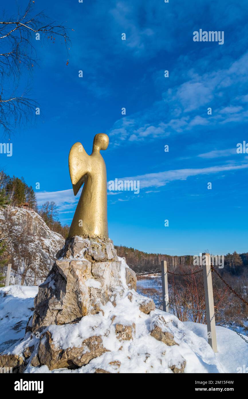 Statue of the angel of one hope in winter. Serga river in Deer streams national Park. Sverdlovsk region, Ural, Russia. Stock Photo