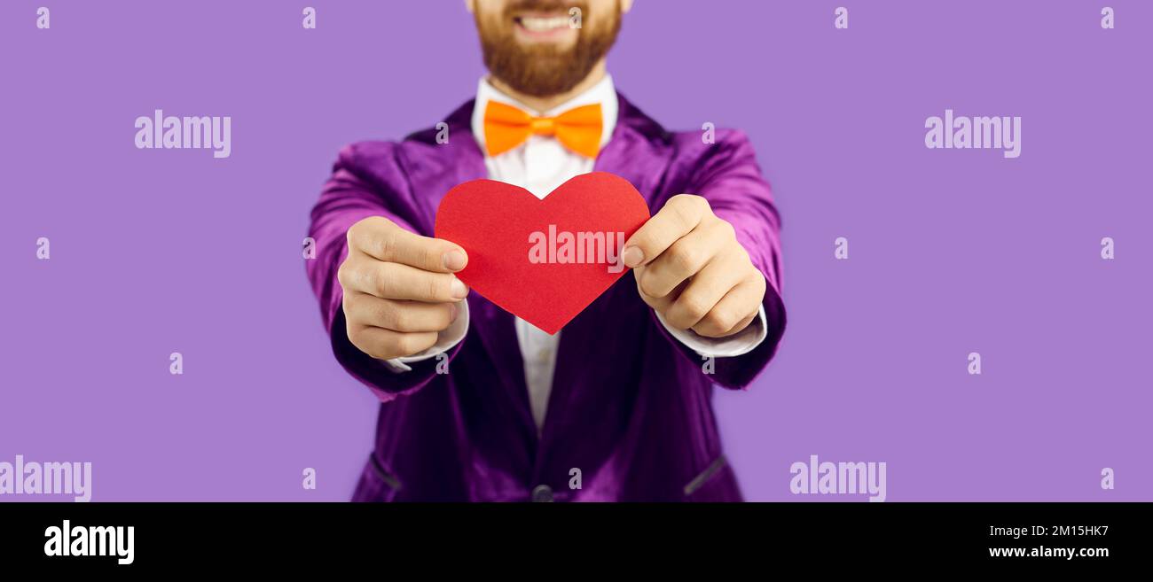 Banner shot of man hold paper heart in hands Stock Photo