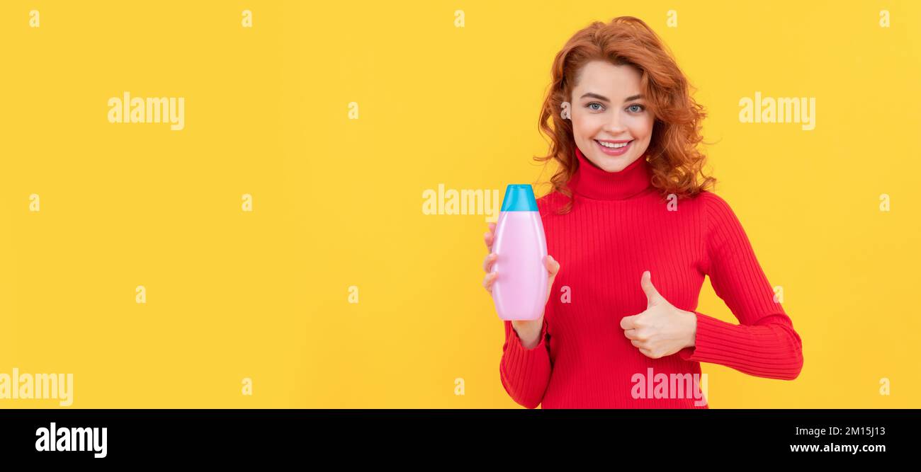 happy woman use shower gel. girl curly hair hold shampoo bottle show