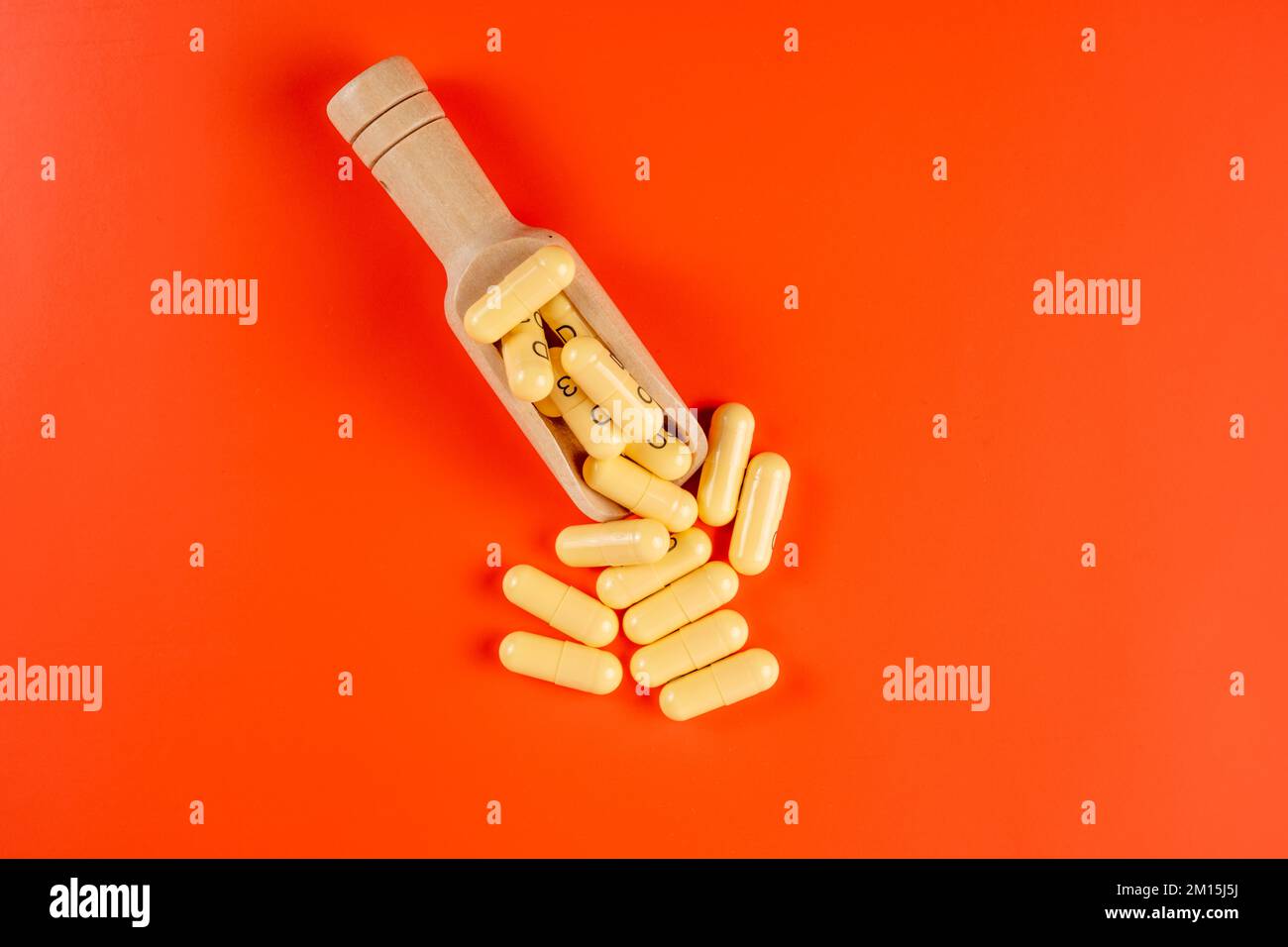 medicinal prescribed pharmaceutical controlled drugs hard capsules isolated on an orange background Stock Photo