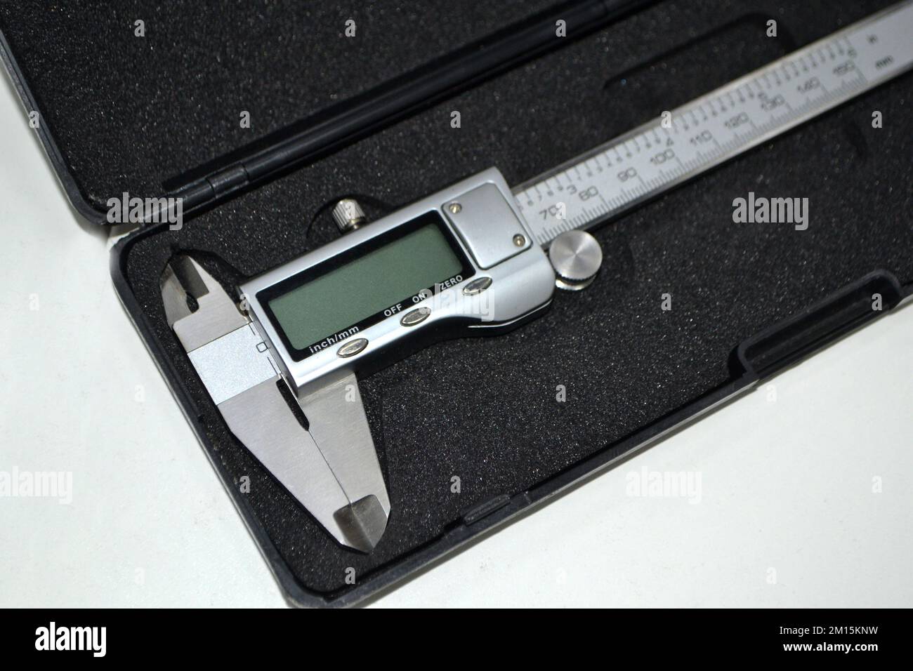 Digital electronic vernier caliper in plastic black box isolated on