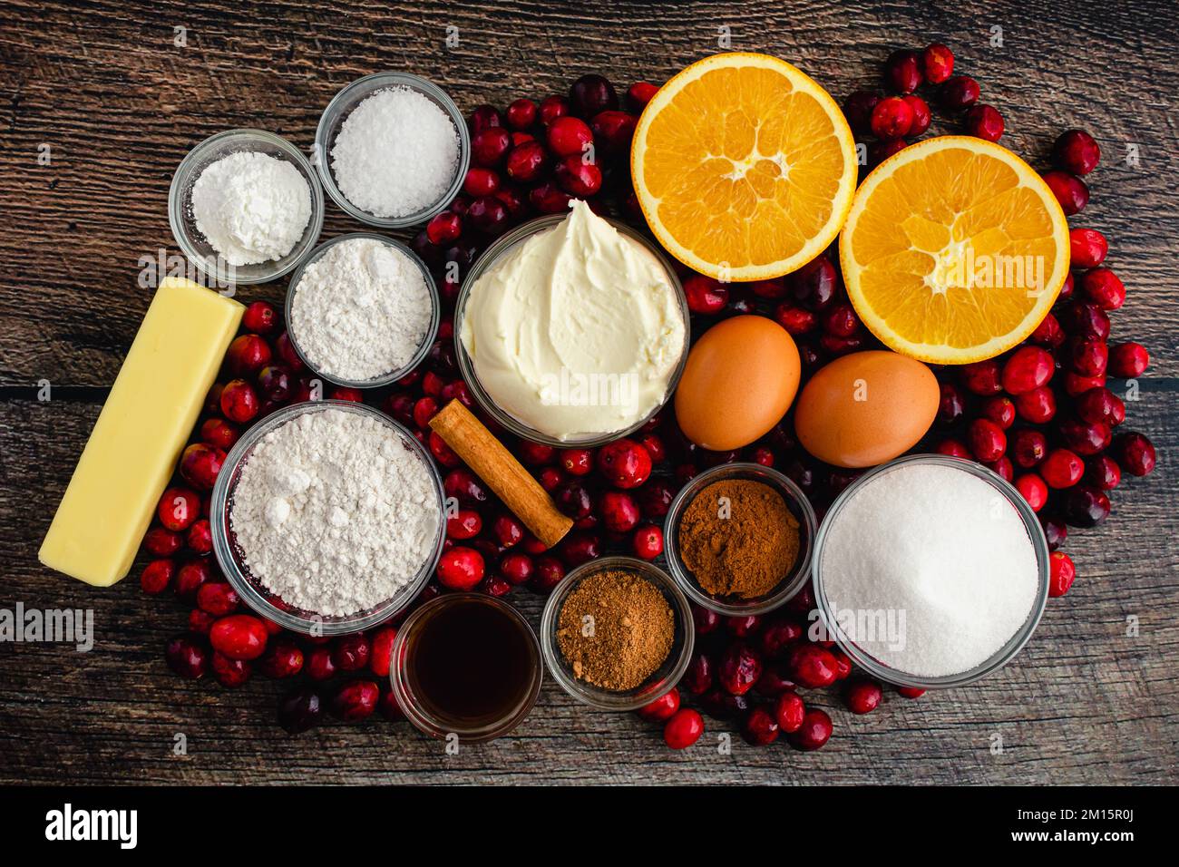 Spiced Mascarpone Cranberry Cake Ingredients on a Wood Table: Fresh cranberries, mascarpone cheese, and other uncooked cake ingredients Stock Photo