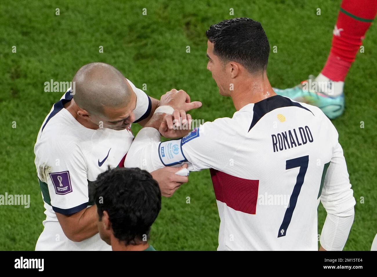 Doha, Qatar. 10th Dec, 2022. Portugal's Pepe (L) gives the captain's armband to Cristiano Ronaldo before he gets onto the pitch during the second-half of Quarterfinal of the 2022 FIFA World Cup at Al Thumama Stadium in Doha, Qatar, Dec. 10, 2022. Credit: Zheng Huansong/Xinhua/Alamy Live News Stock Photo