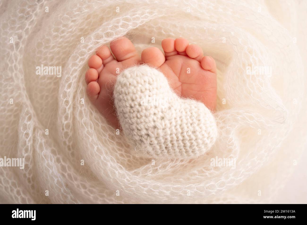 The tiny foot of a newborn baby. Soft feet of a new born in a white wool blanket Stock Photo Alamy
