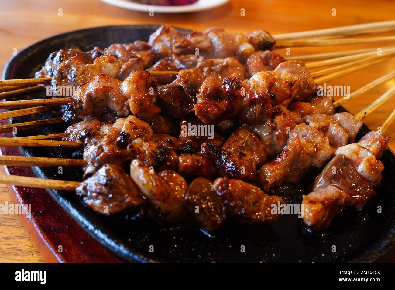 Indonesian lamb satay skewers served on iron hot plate Stock Photo Alamy