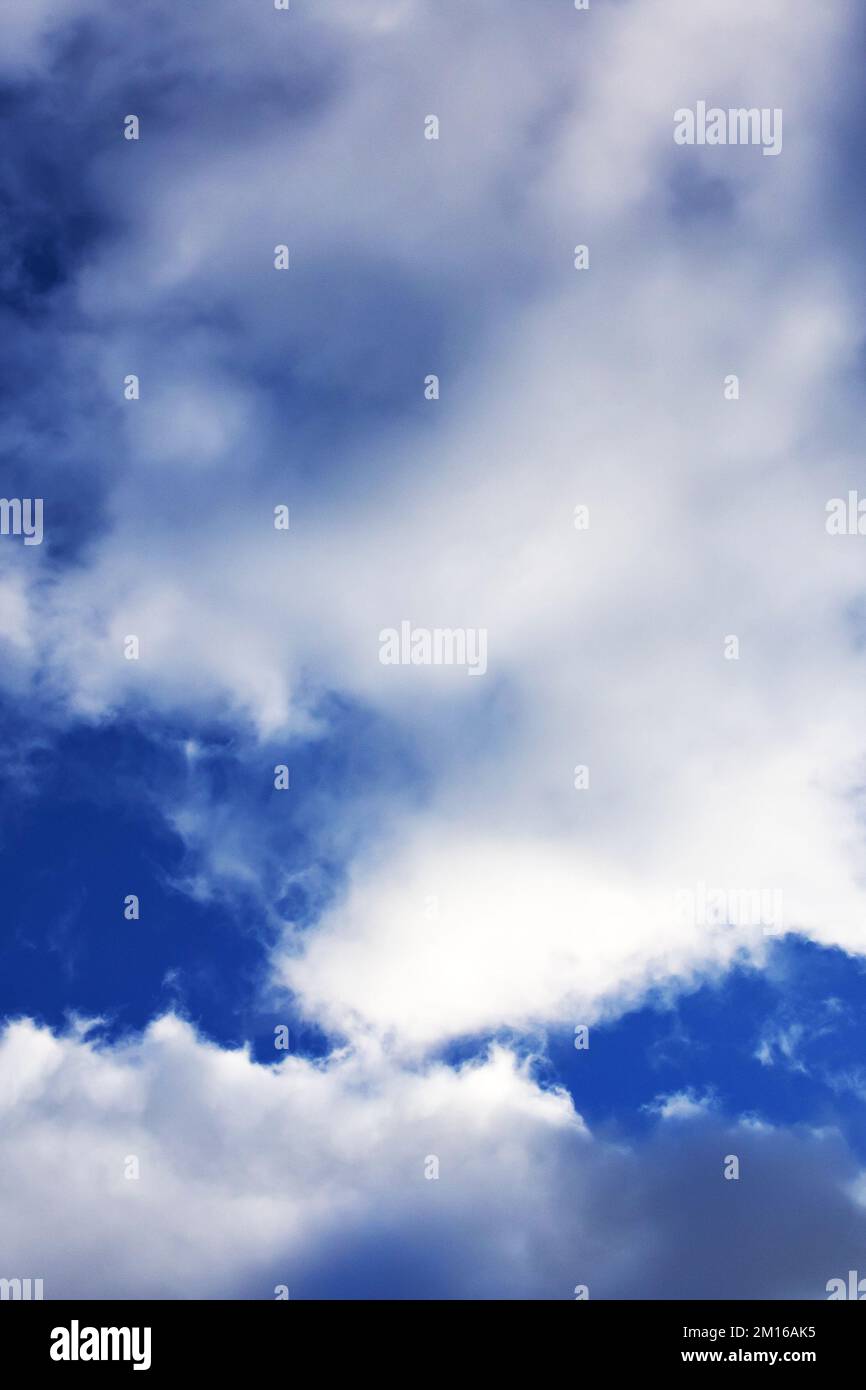 Fluffy clouds in the bright blue sky, nature background Stock Photo - Alamy