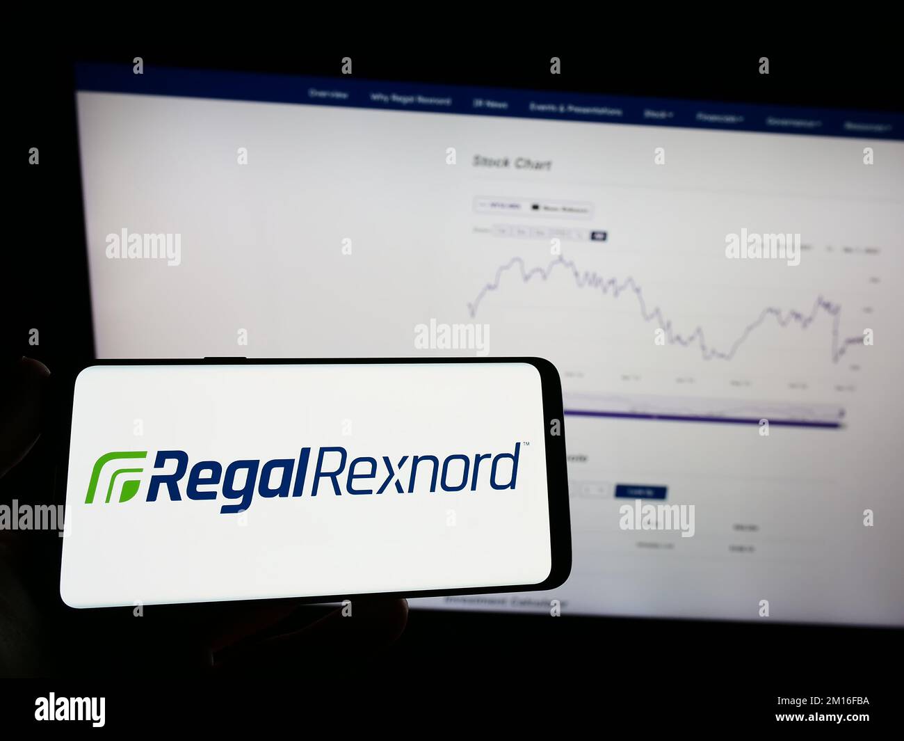 Person holding mobile phone with logo of American motor company Regal