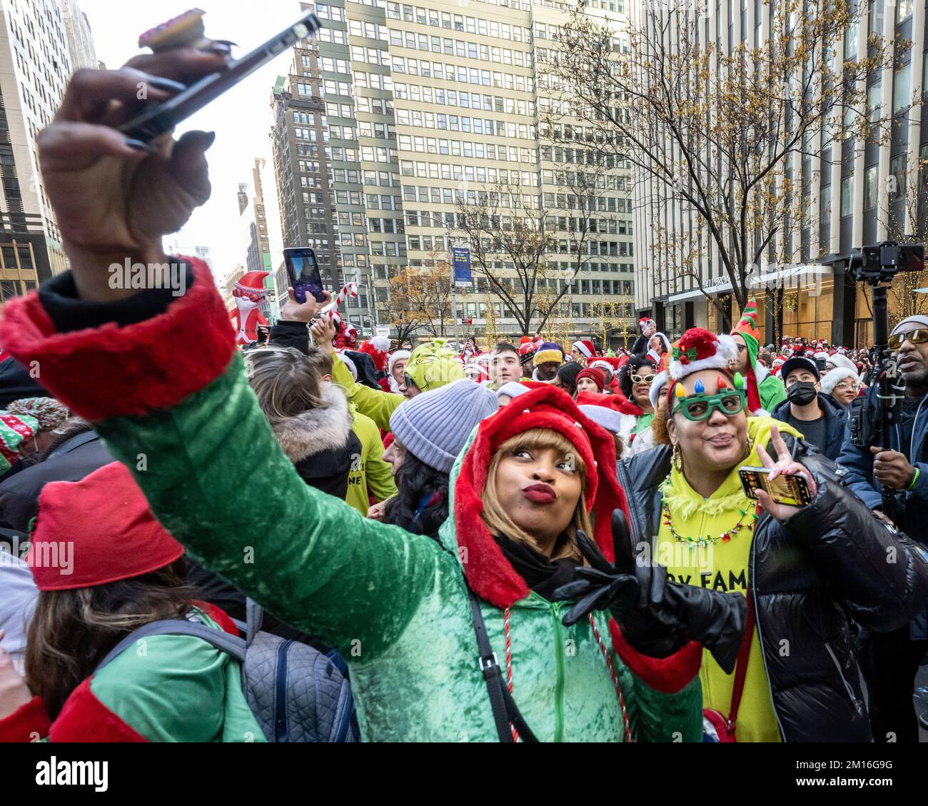 New York, USA. 10th Dec, 2022. Revelers dressed as Santa Claus have fun near Times Square during the annual SantaCon in New York City. Credit: Enrique Shore/Alamy Live News Stock Photo