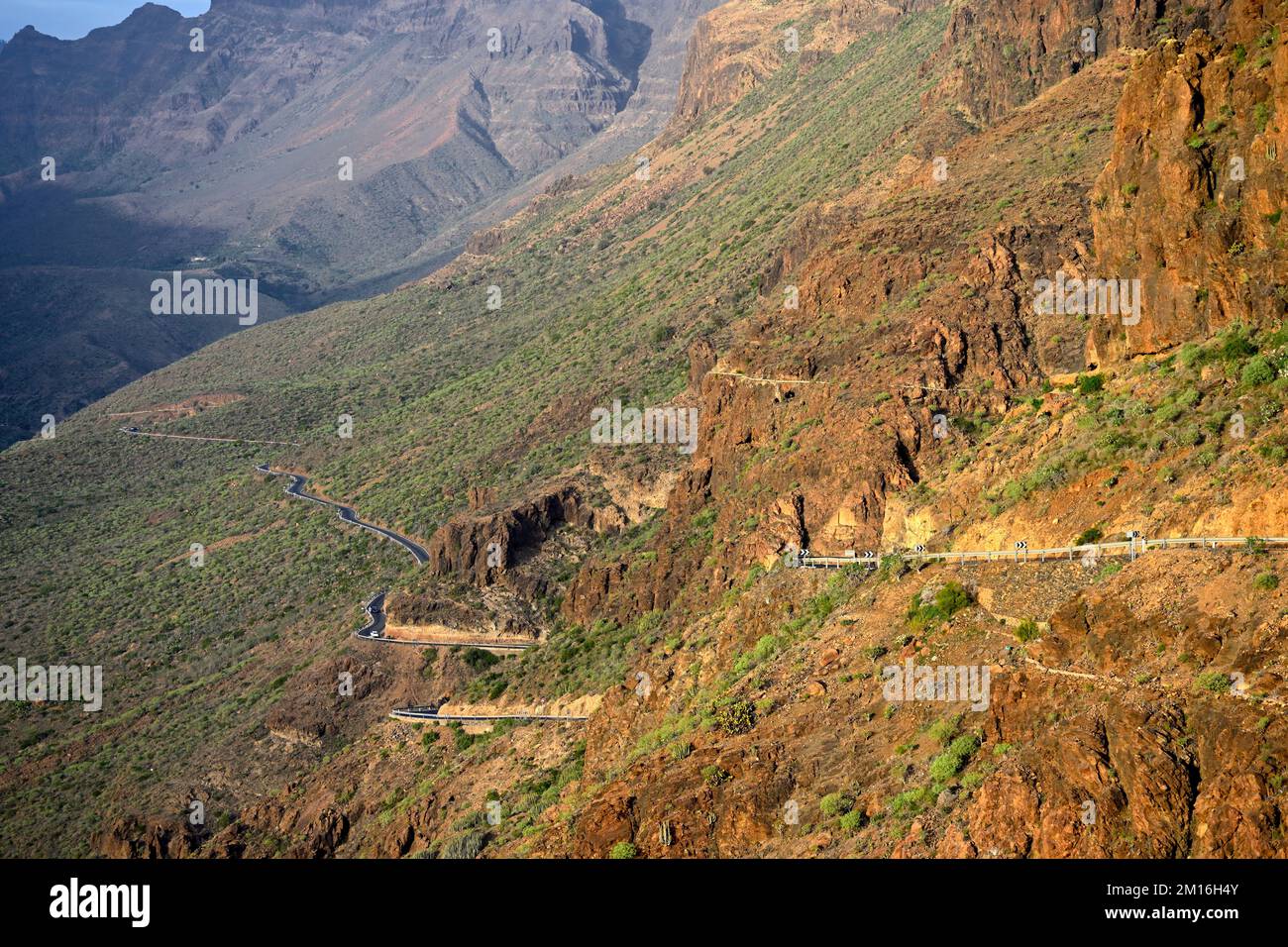Twisting road along rugged mountains and valley of Bartolomé de Tirajana valley, Gran Canaria Stock Photo