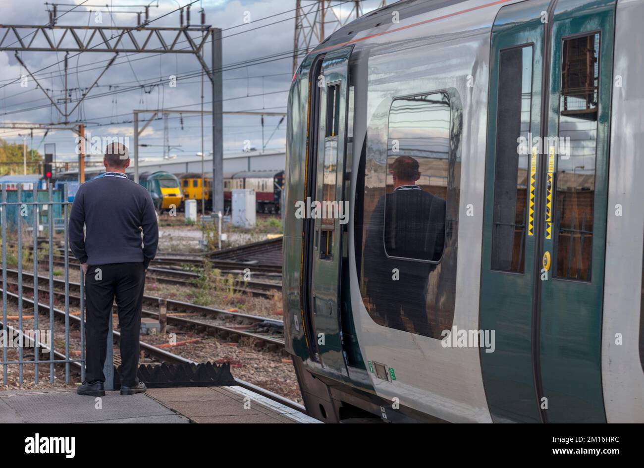 London North Western railway train driver stood by his train at Crewe railway station Stock