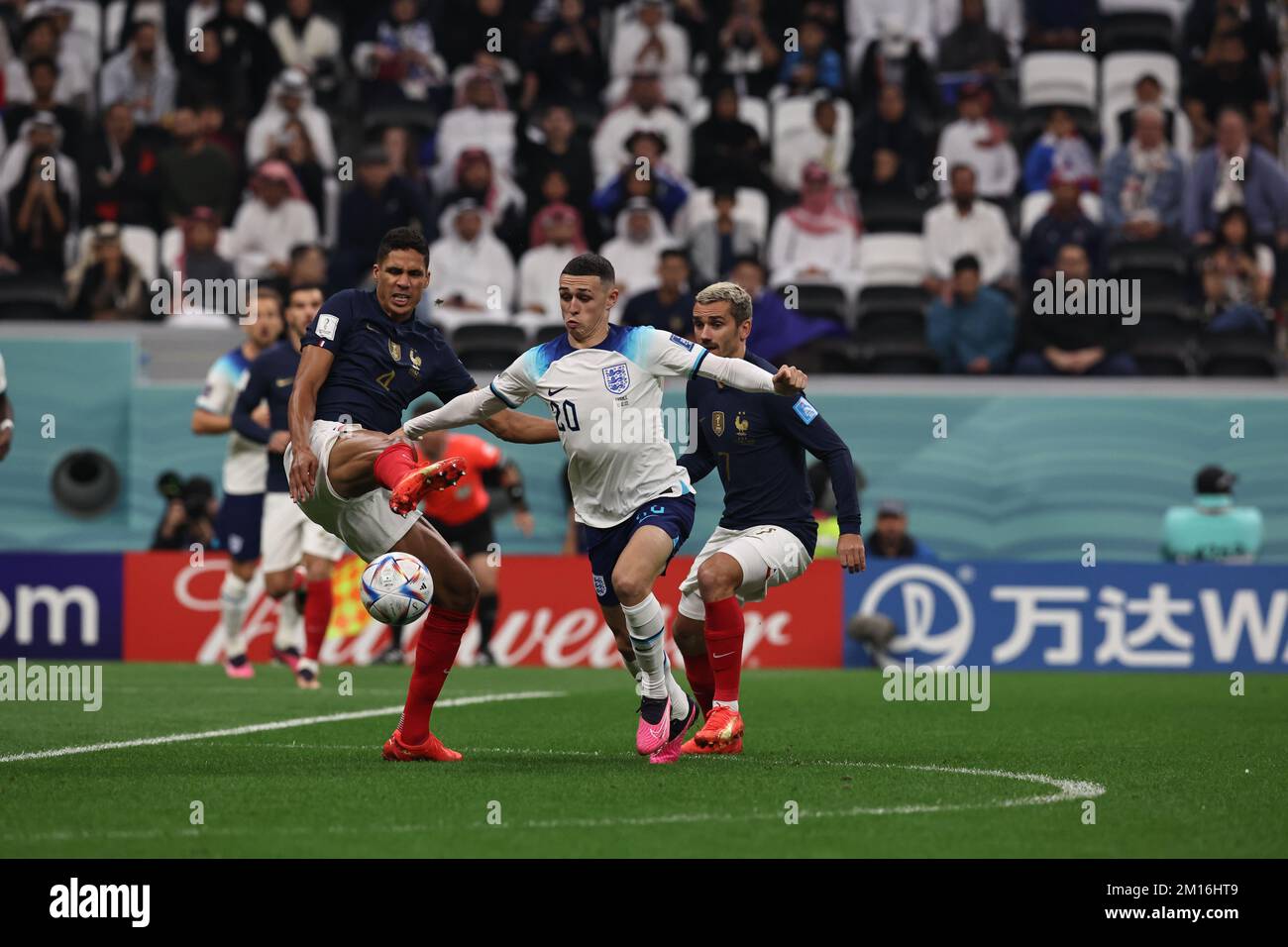 Al Khor, Qatar, on December 9, 2022. England's midfielder Phil Foden vies for the ball with French defender Raphael Varane and Antoine Griezmann during the  World Cup FIFA Qatar 2022 round of quarter finals match between England and France at Al Bayt Stadium in Al Khor, Qatar, on December 9, 2022. (Alejandro PAGNI / PHOTOXPHOTO) Credit: Alejandro Pagni/Alamy Live News Stock Photo