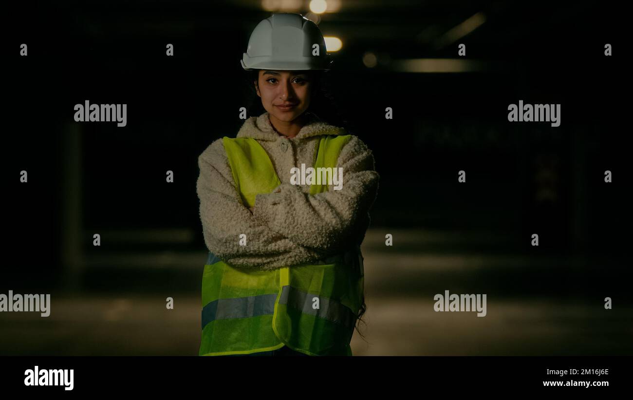 Professional engineer female architect inspector builder arabian woman in uniform protective helmet posing on parking female worker technician Stock Photo