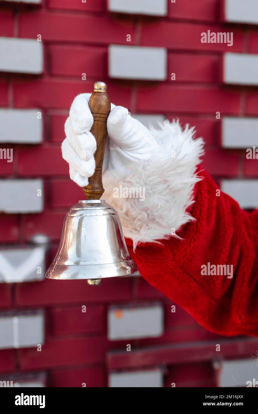 Close-up of a Santa hand holding a Christmas bell Stock Photo