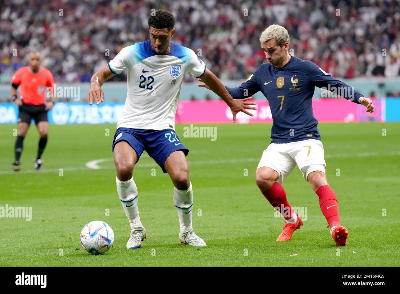 England's Jude Bellingham battles for possession of the ball with France's Antoine Griezmann during the FIFA World Cup Quarter-Final match at the Al Bayt Stadium in Al Khor, Qatar. Picture date: Saturday December 10, 2022. Stock Photo