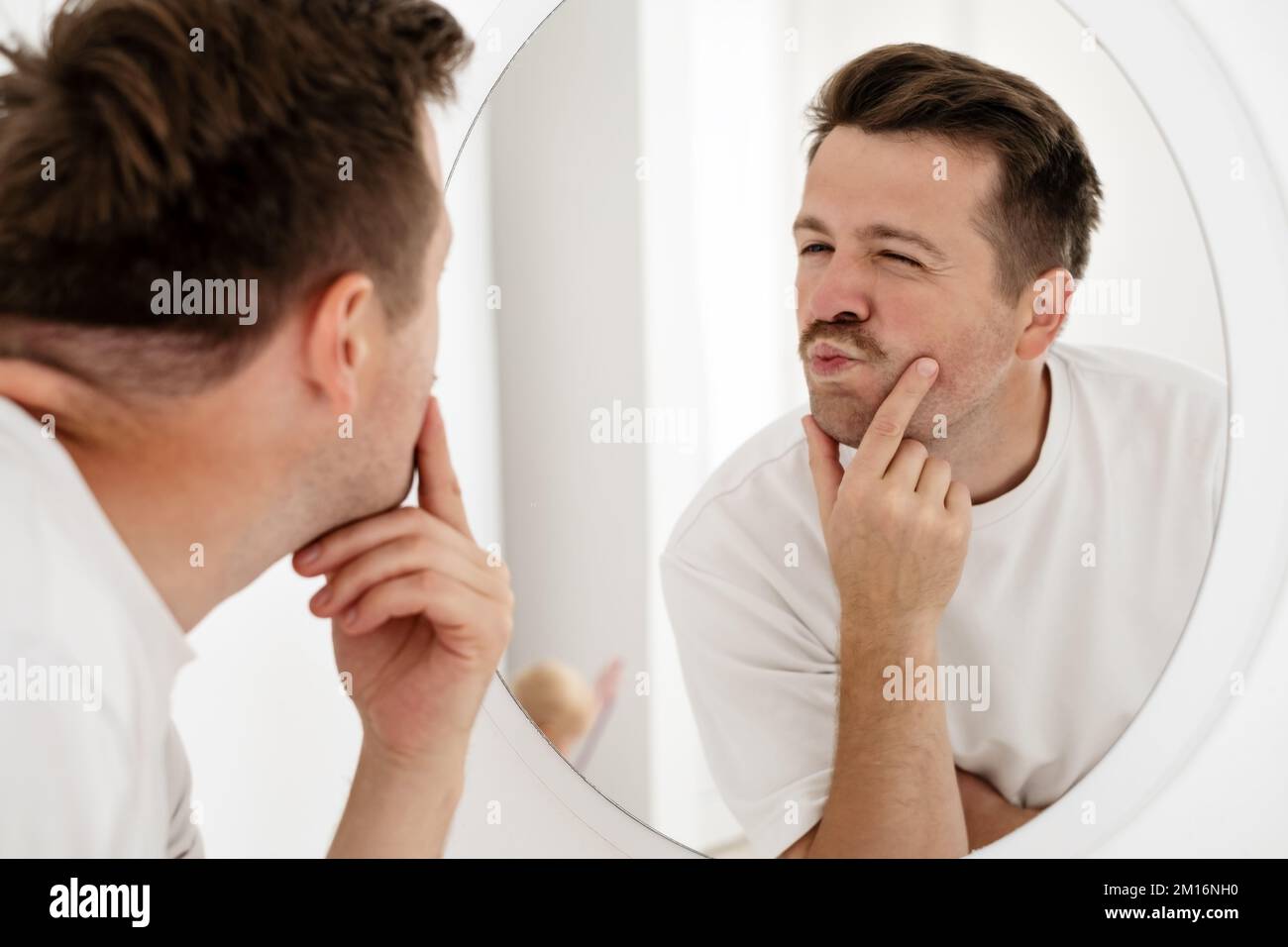 young man trying to cheer himself up before a first date Stock Photo