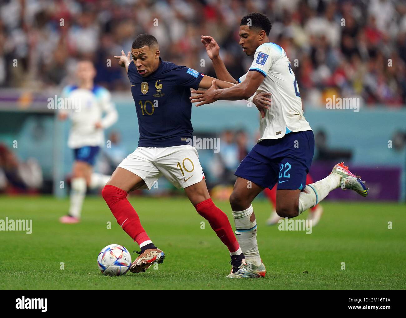 Frances Kylian Mbappe and Englands Jude Bellingham battle for the ball during the FIFA World Cup Quarter-Final match at the Al Bayt Stadium in Al Khor, Qatar