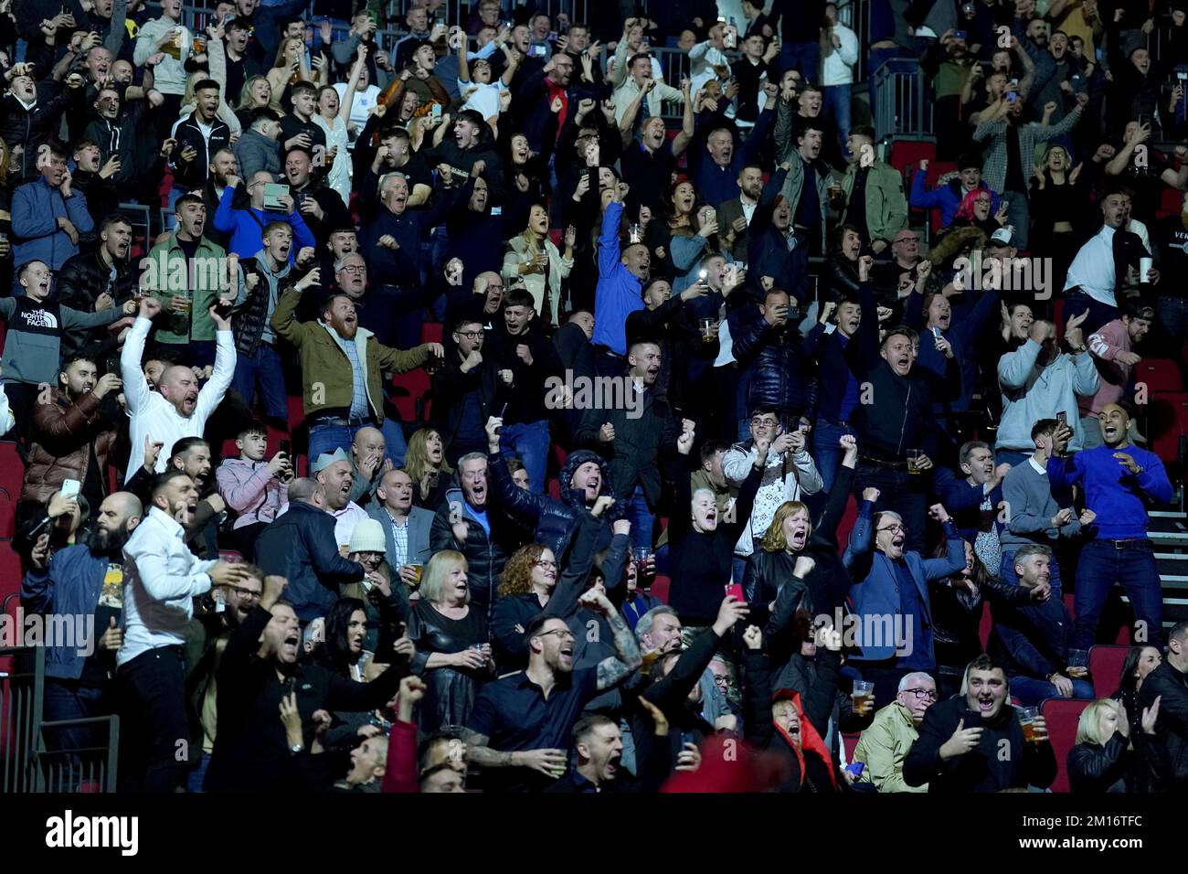 Fans watching England v France in their World Cup quarter-final match celebrate after England's Harry Kane scores from penalty spot, before the resumption of the evening's boxing at the First Direct Arena, Leeds. Picture date: Saturday December 10, 2022. Stock Photo